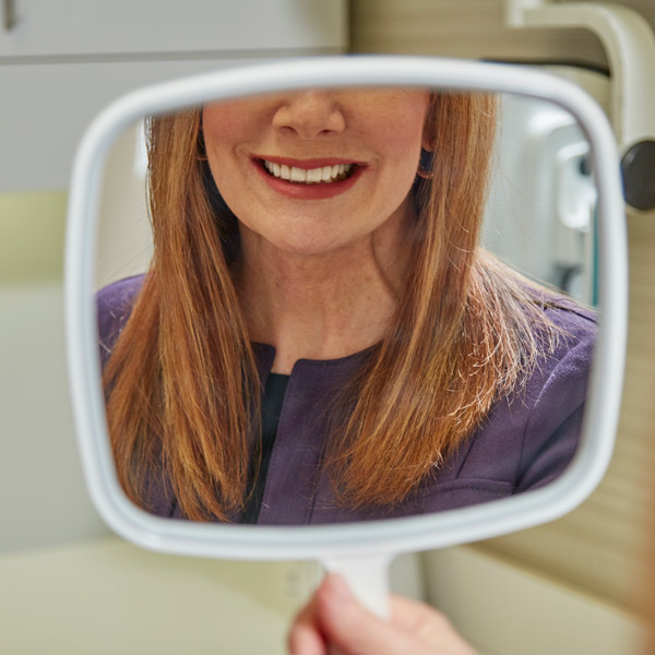 person smiling in mirror